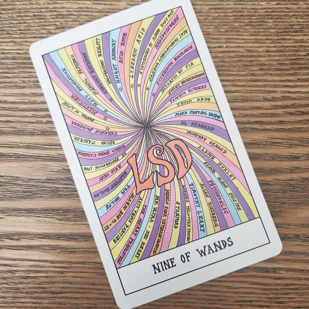 A nine of wands tarot card with the word LSD surrounded by bright, swirling colors.
