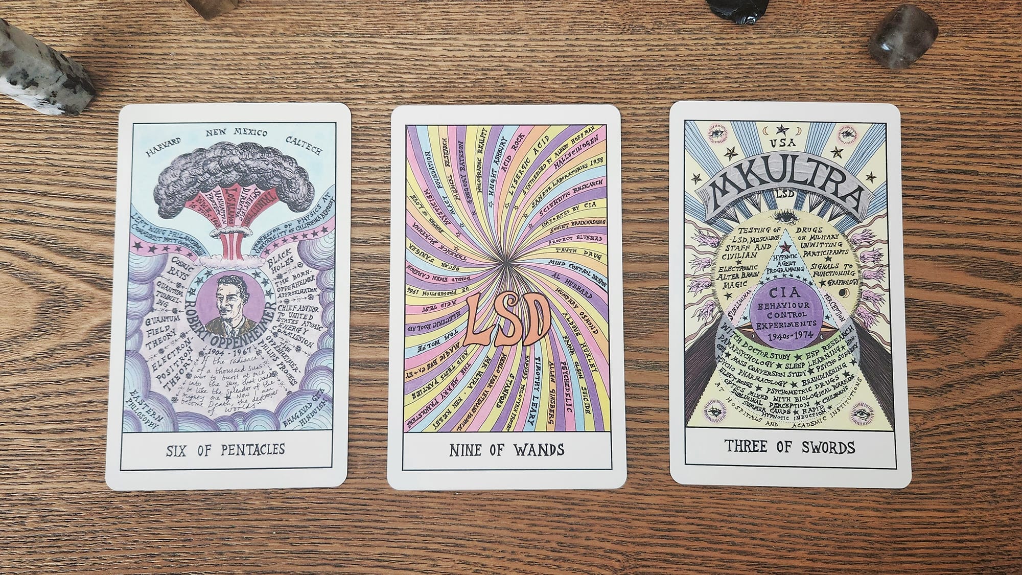 Three tarot cards side by side on a wooden surface.